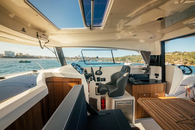 Slide: The Image of Interior of a 2021 Parker 800 Weekend boat with modern amenities and scenic water view. - 14