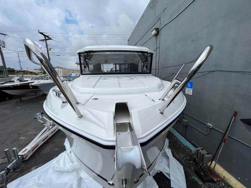 Slide: The Image of Parker 800 Weekend 2021 boat docked near a gray wall on a cloudy day. - 4