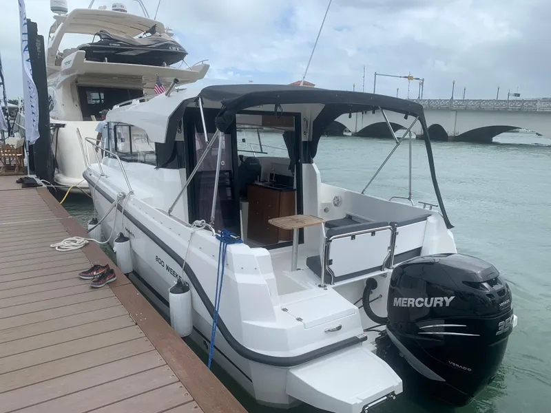 Slide: The Image of Parker 800 Weekend 2021 boat docked, featuring a Mercury outboard motor. - 5