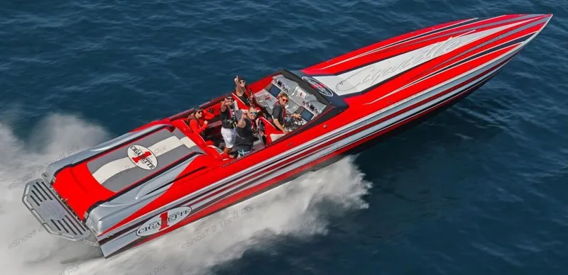 Slide: The Image of 2016 Cigarette 50' Marauder speedboat in red and silver, cruising on open water. - 1