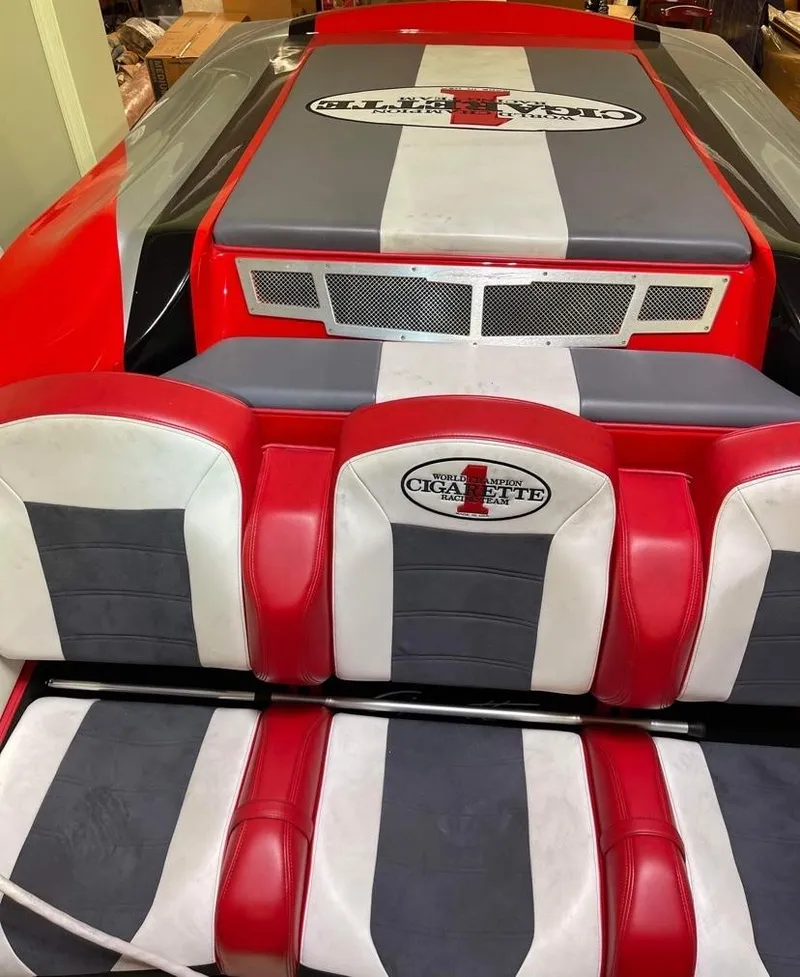 Slide: The Image of 2016 Cigarette 50' Marauder boat interior with red, white, and gray seating. - 19