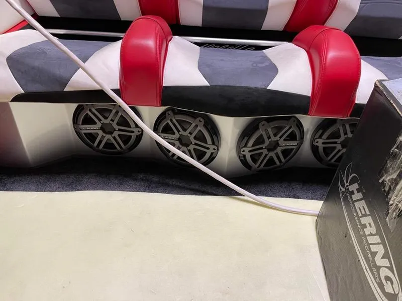 Slide: The Image of 2016 Cigarette 50' Marauder boat interior with red and white seating and audio speakers. - 20