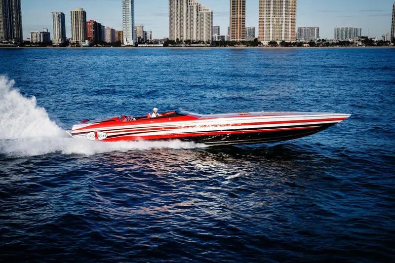 Slide: The Image of 2016 Cigarette 50' Marauder speedboat cruising on blue water near city skyline. - 3