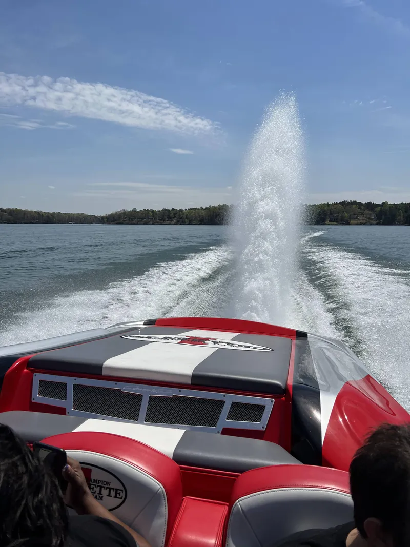 Slide: The Image of 2016 Cigarette 50' Marauder speedboat cruising on a lake under clear skies. - 4