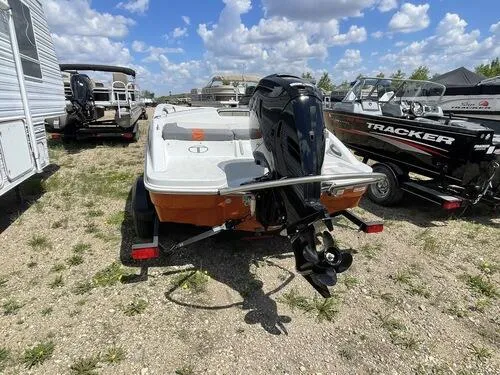 Slide: The Image of 2019 Tahoe T16 boat with outboard motor in a lot with other boats. - 4