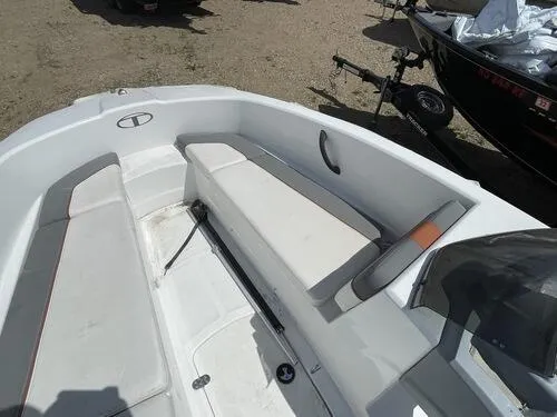 Slide: The Image of 2019 Tahoe T16 boat interior with white seating and storage compartments. - 8