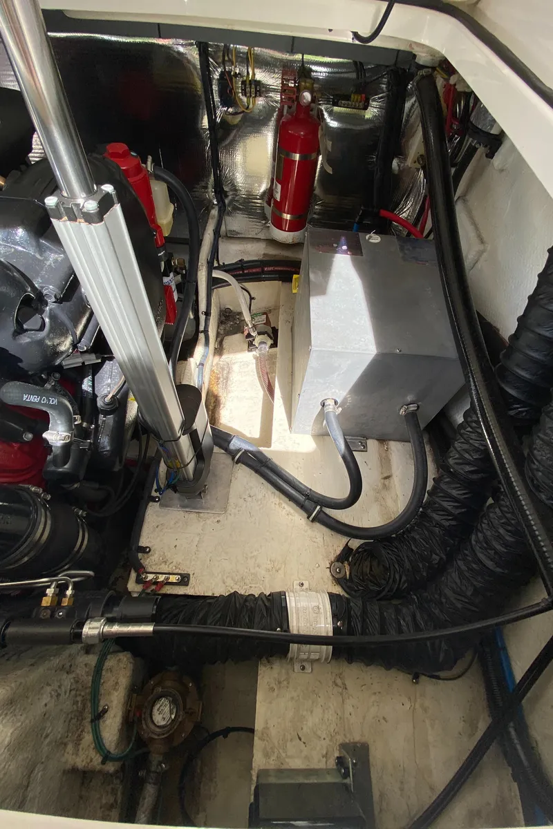 Slide: The Image of Engine compartment of a 2018 Regal 28 Express boat with various mechanical components. - 14