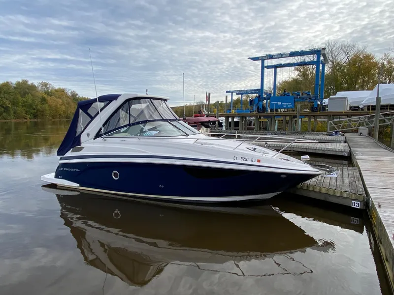 Slide: The Image of 2018 Regal 28 Express boat docked at a marina. - 2