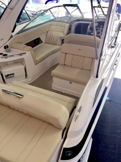 Slide: The Image of 2018 Regal 28 Express boat interior with beige seating and modern dashboard. - 5