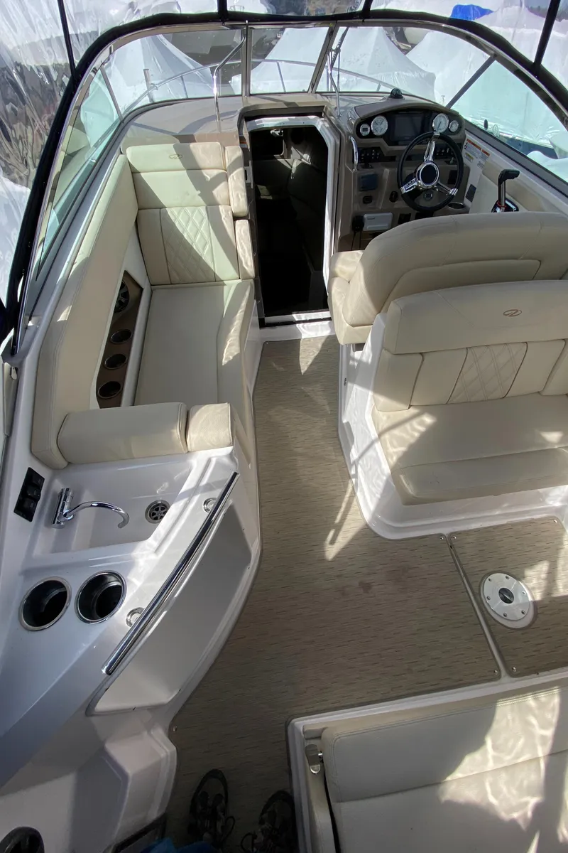 Slide: The Image of 2018 Regal 28 Express boat interior with beige seating and modern dashboard. - 6
