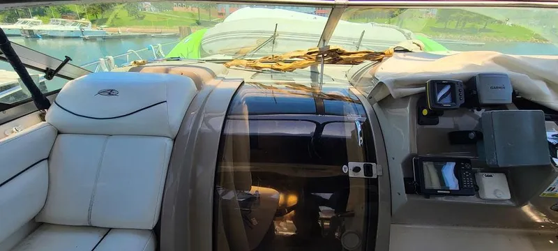 Slide: The Image of 1999 Bayliner 4085 Avanti cockpit with leather seats and navigation equipment. - 14