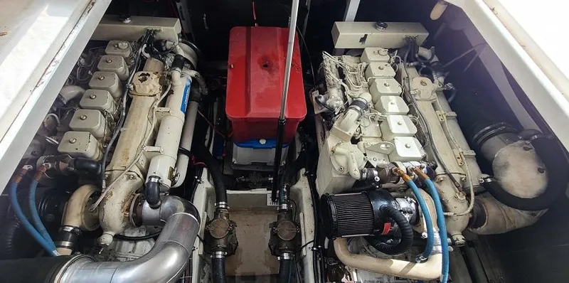 Slide: The Image of 1999 Bayliner 4085 Avanti engine compartment with dual engines and red battery box. - 15