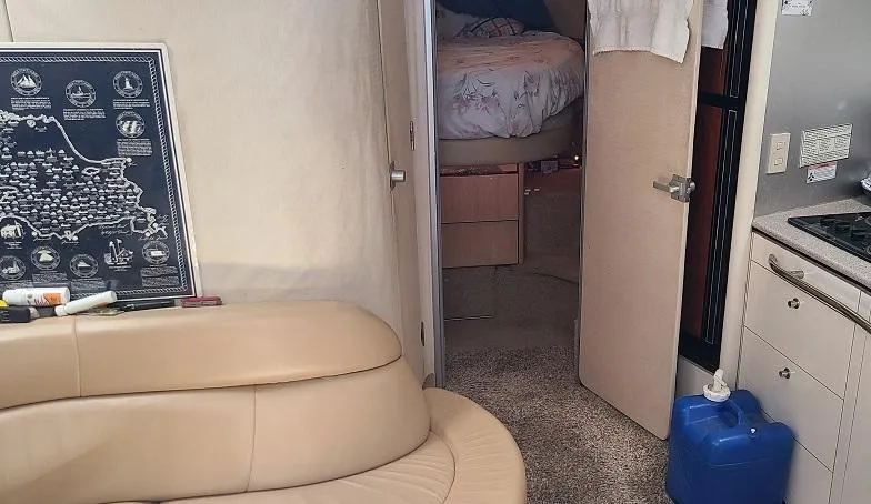 Slide: The Image of Interior of 1999 Bayliner 4085 Avanti yacht with beige seating and cozy bedroom. - 21