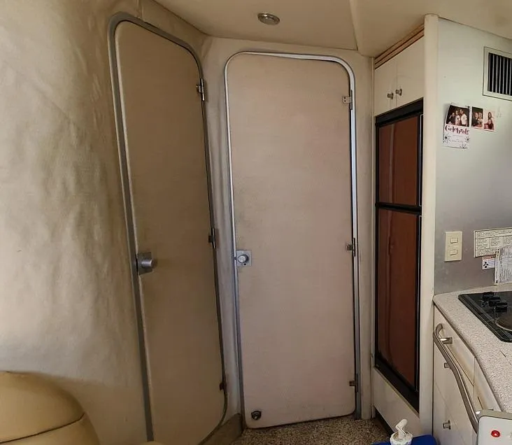 Slide: The Image of Interior of 1999 Bayliner 4085 Avanti boat with doors and kitchenette. - 22
