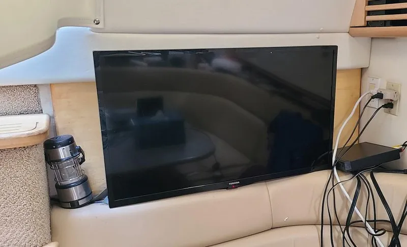 Slide: The Image of Flat-screen TV setup inside 1999 Bayliner 4085 Avanti boat cabin. - 26
