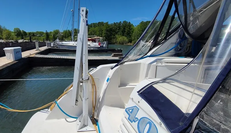 Slide: The Image of 1999 Bayliner 4085 Avanti docked at a marina on a sunny day. - 3