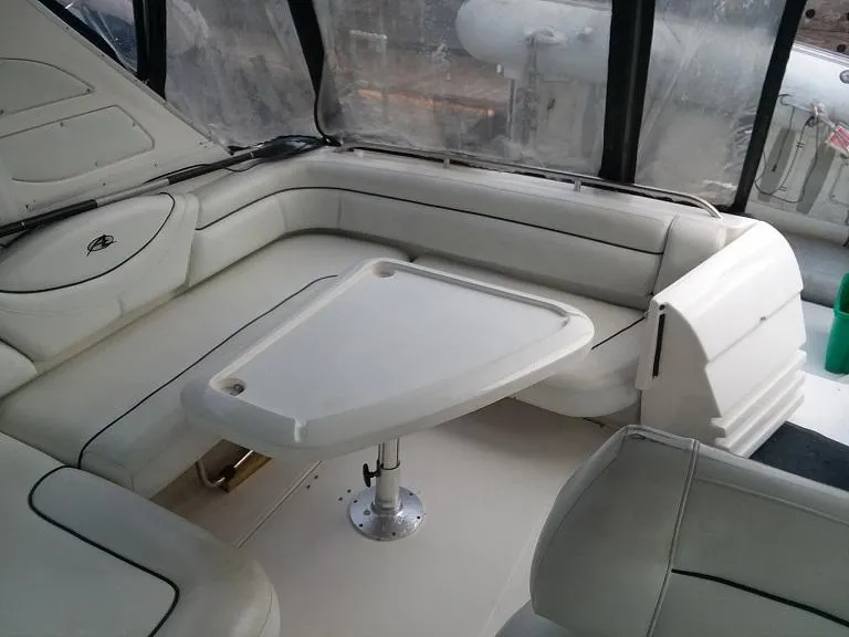 Slide: The Image of 1999 Bayliner 4085 Avanti boat interior with white seating and table. - 5