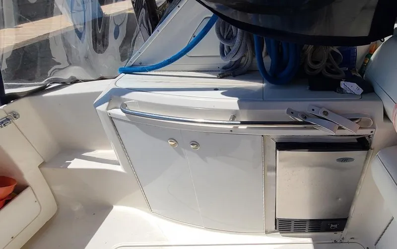 Slide: The Image of 1999 Bayliner 4085 Avanti yacht cockpit with storage and mini fridge. - 7