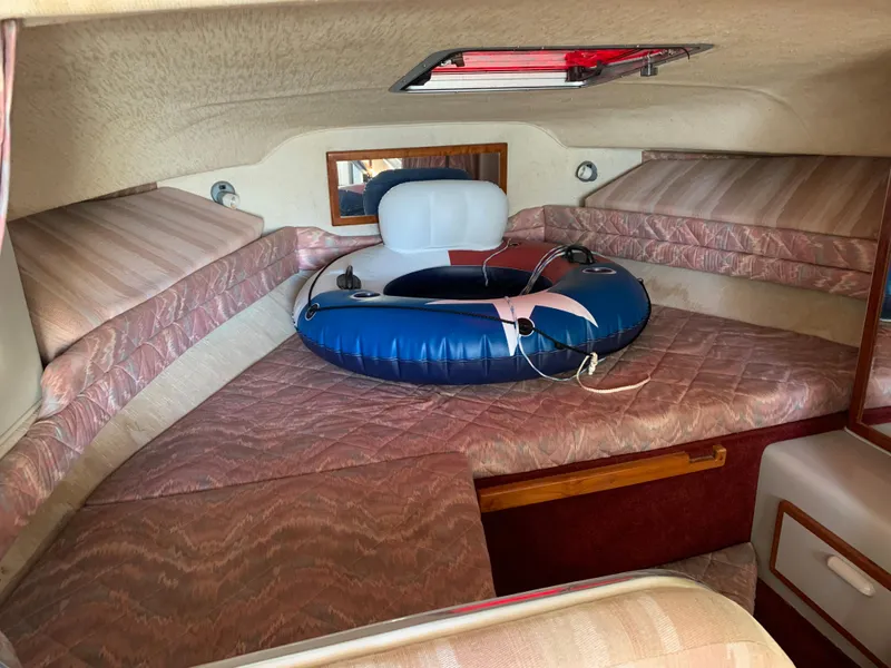 Slide: The Image of Interior cabin of 1991 Sea Ray 290 Sundancer with seating and inflatable ring. - 14