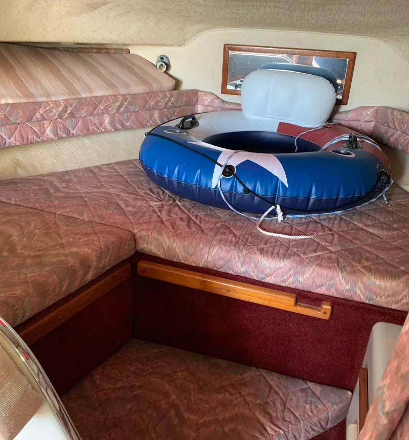 Slide: The Image of 1991 Sea Ray 290 Sundancer cabin with inflatable tube on bed. - 16