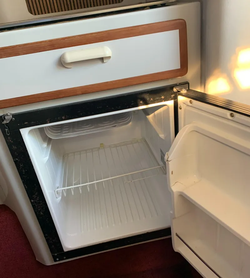 Slide: The Image of 1991 Sea Ray 290 Sundancer boat interior fridge, open and empty. - 20