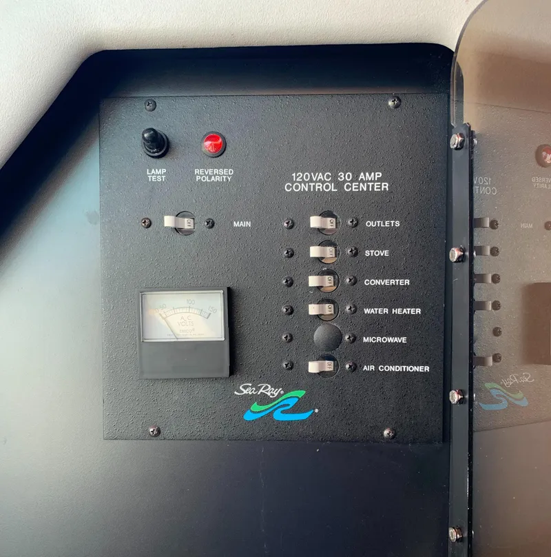 Slide: The Image of Control panel of a 1991 Sea Ray 290 Sundancer boat, featuring various switches and indicators. - 22