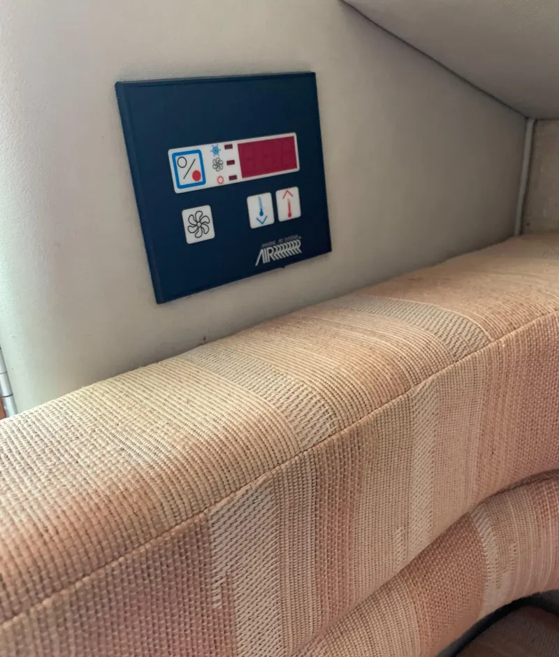 Slide: The Image of 1991 Sea Ray 290 Sundancer cabin interior with control panel and cushioned seating. - 23