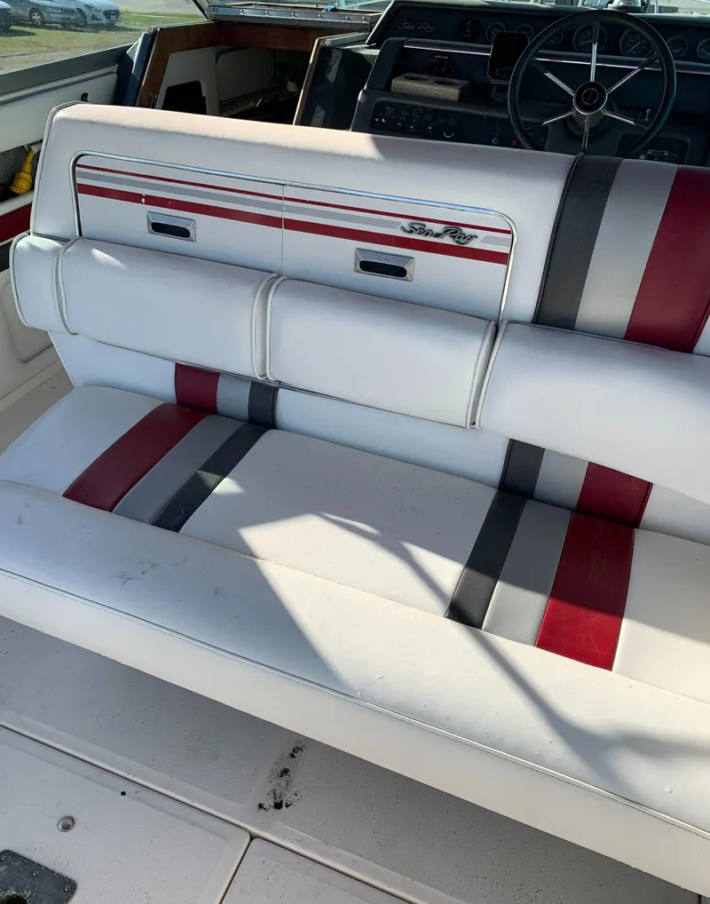 Slide: The Image of 1991 Sea Ray 290 Sundancer boat interior with white, red, and gray seating. - 6