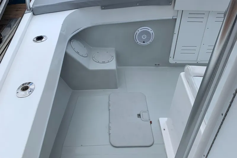 Slide: The Image of 2011 Dusky 28xl boat interior with storage compartments and seating. - 4