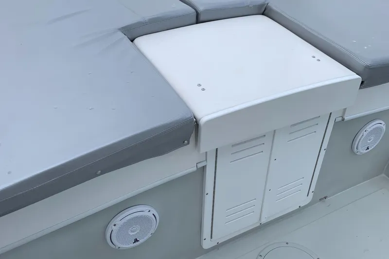 Slide: The Image of Dusky 28xl 2011 boat interior with cushioned seating and storage compartments. - 5