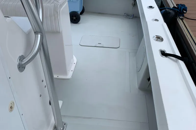 Slide: The Image of 2011 Dusky 28xl boat deck with seating and storage compartments. - 6