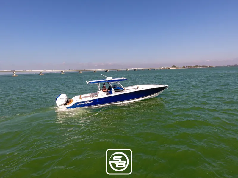 Slide: The Image of 2021 Nor-Tech 390 Sport boat cruising on open water. - 13