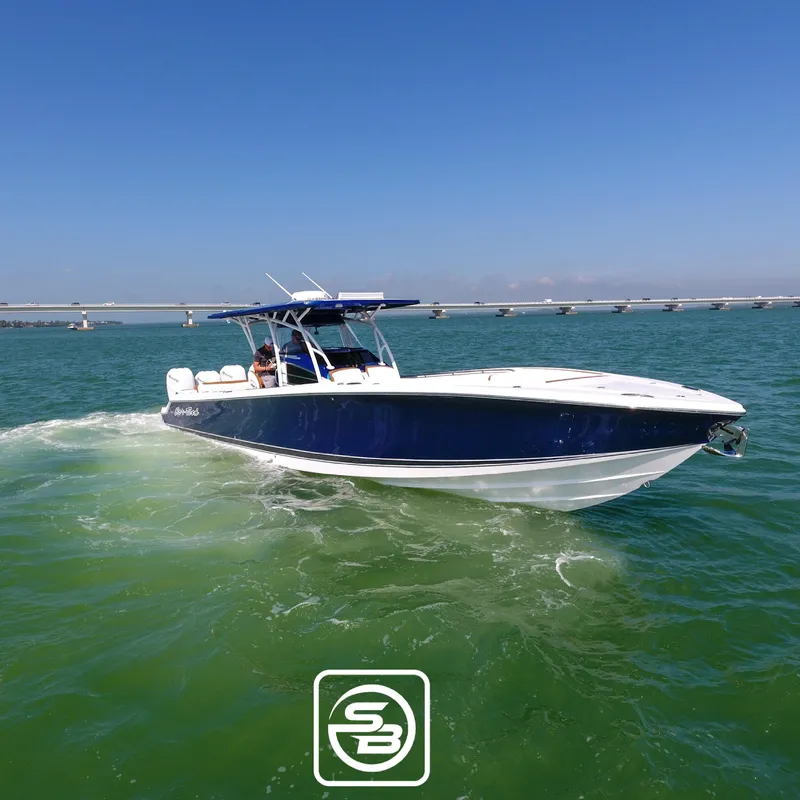 Slide: The Image of 2021 Nor-Tech 390 Sport boat cruising on clear blue water. - 17