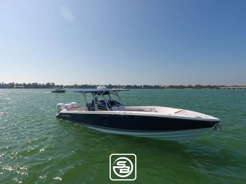Slide: The Image of 2021 Nor-Tech 390 Sport boat on calm waters under clear blue sky. - 3