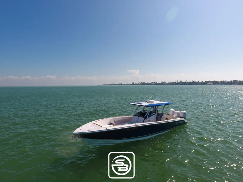 Slide: The Image of 2021 Nor-Tech 390 Sport boat on calm waters under clear blue sky. - 5