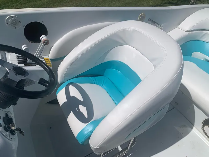 Slide: The Image of 1999 Baja 29 Outlaw SST boat interior with white and blue seats. - 14