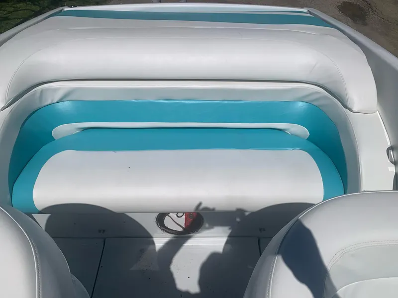 Slide: The Image of 1999 Baja 29 Outlaw SST boat interior with white and teal seating. - 16