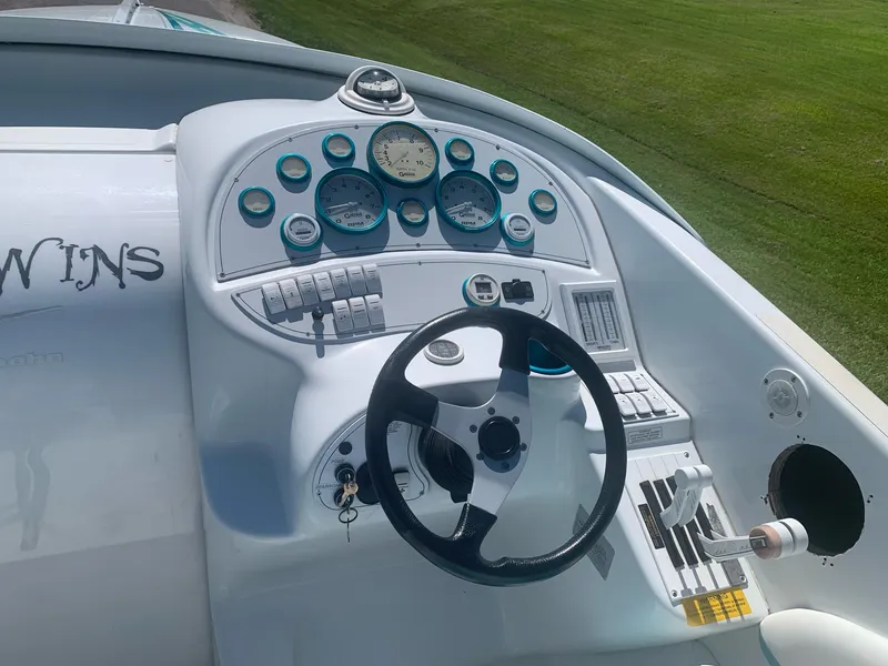 Slide: The Image of 1999 Baja 29 Outlaw SST boat dashboard with steering wheel and gauges. - 18
