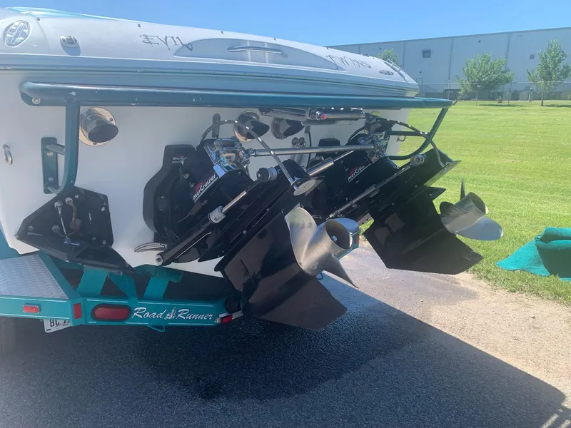 Slide: The Image of 1999 Baja 29 Outlaw SST boat rear view showing dual propellers and outboard motors. - 22