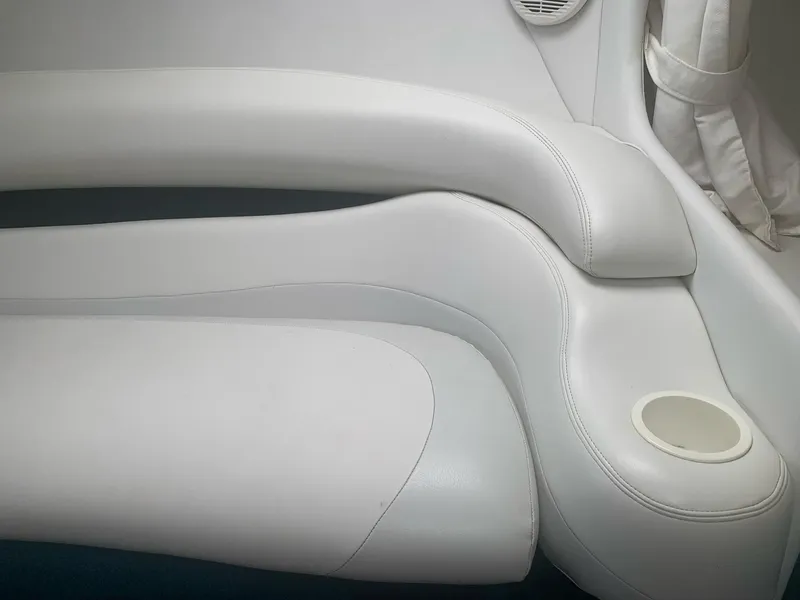 Slide: The Image of Interior seating of a 1999 Baja 29 Outlaw SST boat with white upholstery. - 25