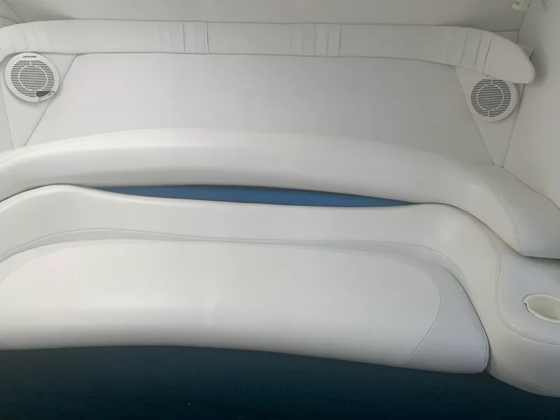 Slide: The Image of Interior seating of a 1999 Baja 29 Outlaw SST boat with white upholstery. - 28
