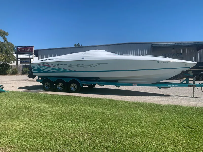 Slide: The Image of 1999 Baja 29 Outlaw SST speedboat on a trailer in front of a service center. - 3