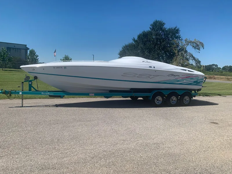 Slide: The Image of 1999 Baja 29 Outlaw SST speedboat on a trailer in a parking lot. - 8