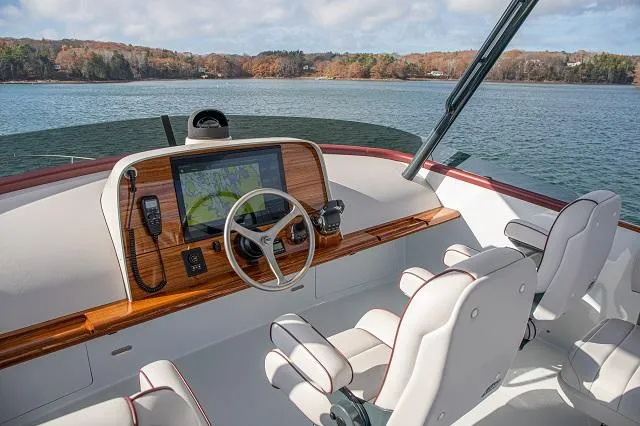 Slide: The Image of Luxurious 2027 C.W. Hood 57 LM yacht cockpit with modern navigation system on serene water. - 11