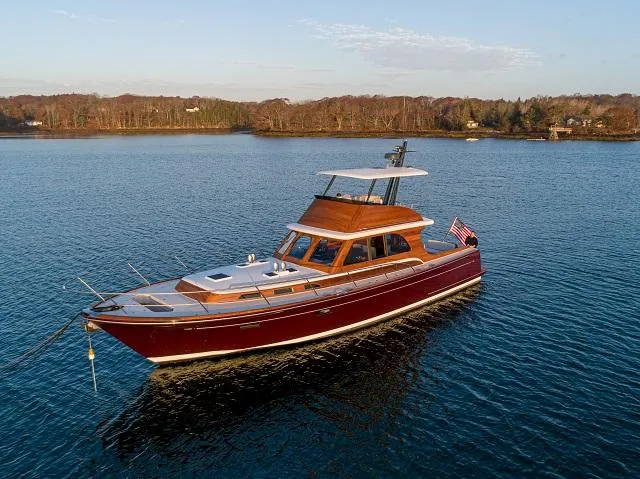 Slide: The Image of Luxurious 2027 C.W. Hood 57 LM yacht cruising on serene waters. - 2