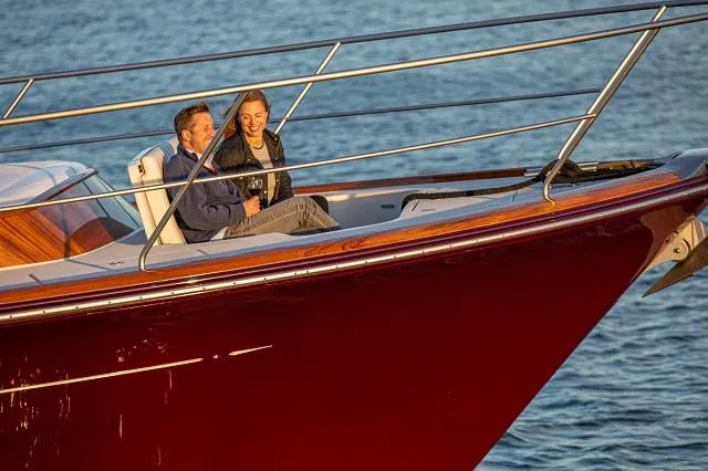 Slide: The Image of Couple enjoying a sunset cruise on a 2027 C.W. Hood 57 LM yacht. - 5
