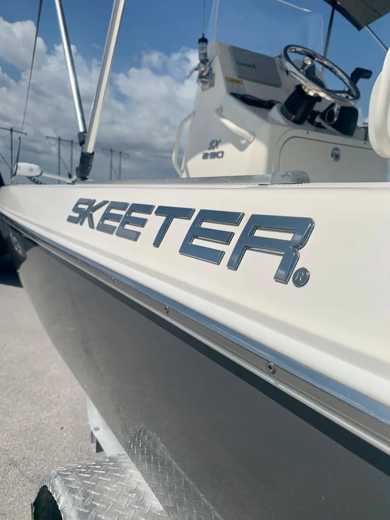 Slide: The Image of 2016 Skeeter SX230 boat side view with logo and console. - 10