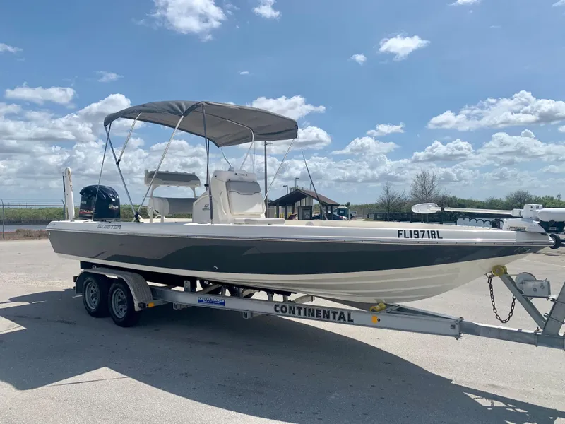 Slide: The Image of 2016 Skeeter SX230 boat on a Continental trailer under a blue sky. - 11