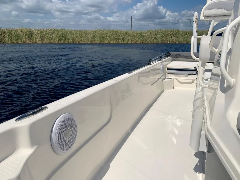 Slide: The Image of 2016 Skeeter SX230 boat interior on a calm water body with clear skies. - 15