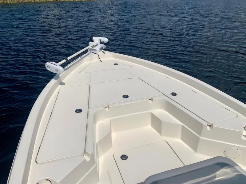 Slide: The Image of 2016 Skeeter SX230 boat bow on calm water. - 19